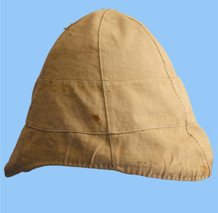 A khaki cover over a white helmet. Note that the drawstring used to tighten and secure the cover to the helmet is missing. (Author’s collection)