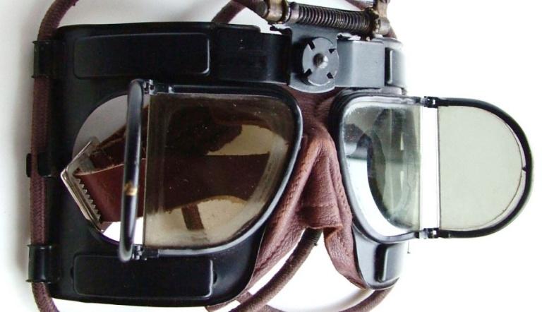 Figure 26. The first new design of goggle for the RAF in WWII, the Mk IV. That its ancestry was the earlier folding split lens goggle types is perhaps best shown by the hinged ‘window’ frames of the first Mk IV model. As they were supposed to be worn continually by pilots the concertina fold-ability of the earlier soft mask versions was deliberately missing. The ‘lenses’ were officially called ‘windows’ by the RAF; as the term lens intrinsically implies a distortion of light in some way. (image www.historicflyingclothing.com)