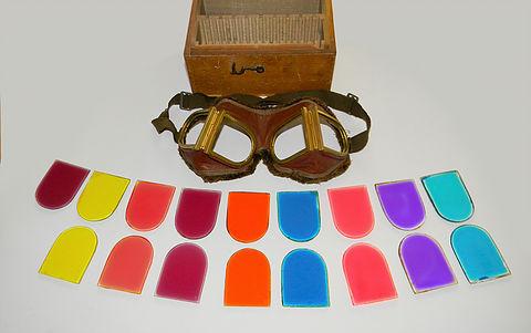 Figure 9. WWI British, Royal Naval Air Service, specialist goggles with numerous different coloured lenses used for signal flare enhancement. These had strong brass frames to withstand repeated lens changes, and had a thick fur trim to the back of the leather mask.